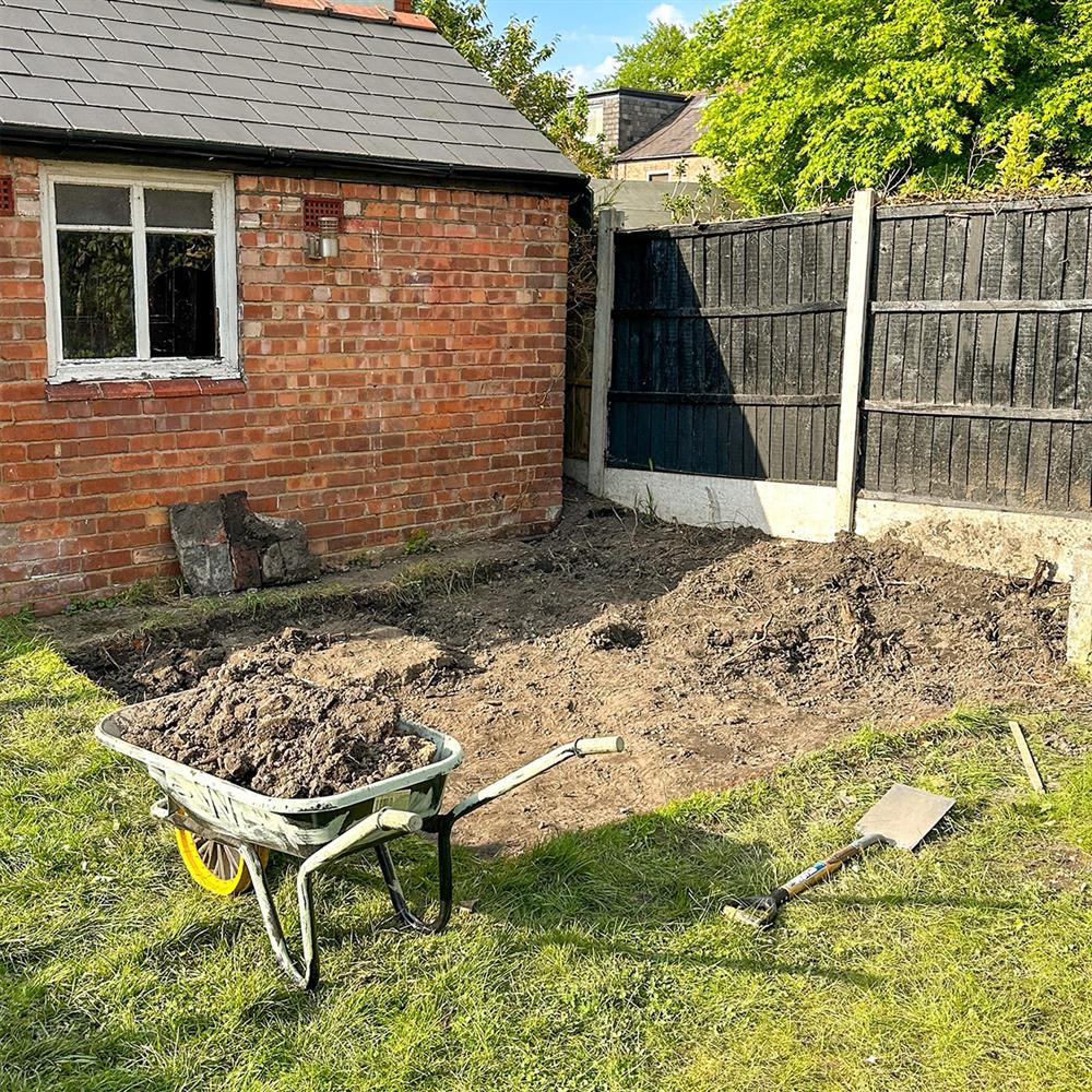 A lawned garden in-progress to become a paved patio area